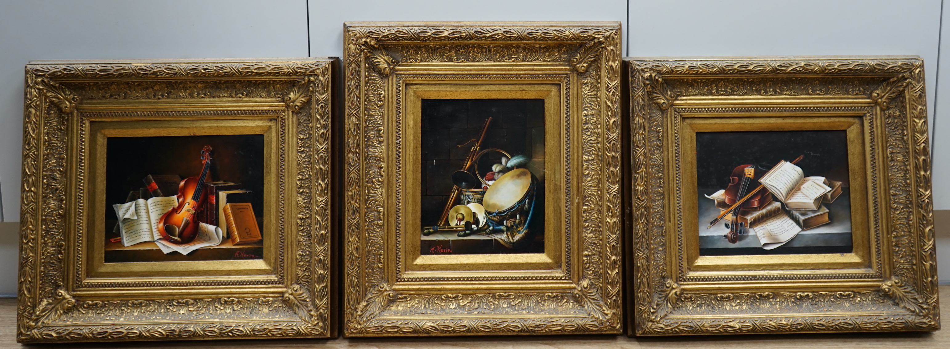 A Herin, set of three contemporary oils on board, Still lifes of musical instruments and sheet music, two signed, each 19 x 24cm, ornate gilt framed